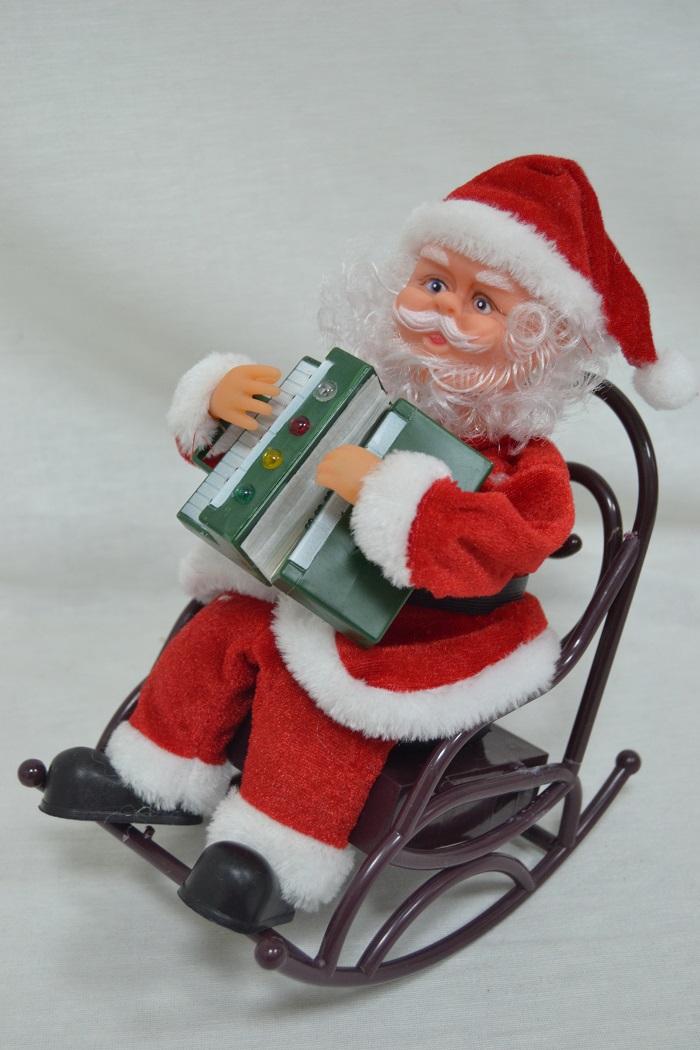 Santa Claus playing an instrument on a swing